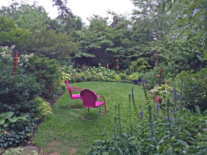 Back garden view from porch: Hibiscus 'Plum Crazy', Lobelia siphilitica; pink chairs'; Savin; 8/12/15